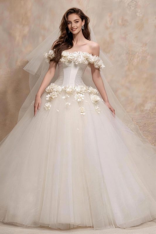 White fitted tulle wedding gown featuring ruching, floral details, and a voluminous skirt.