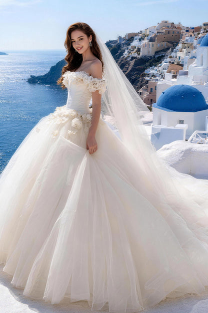 White fitted tulle wedding gown featuring ruching, floral details, and a voluminous skirt.