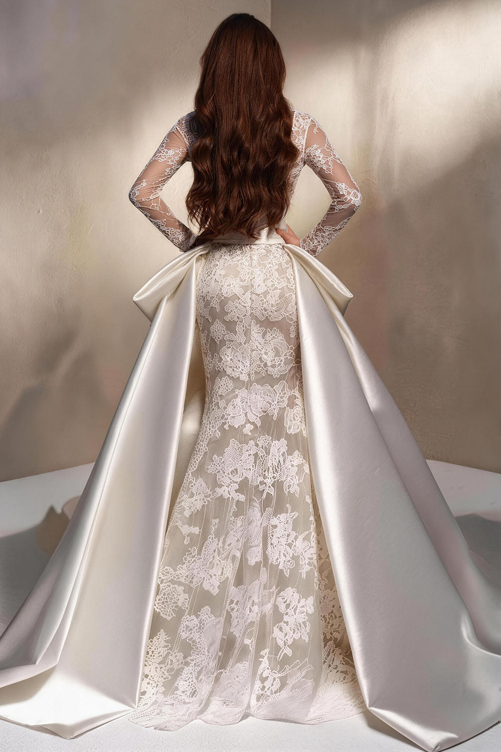 Fitted, ruched wedding gown featuring white tulle, satin, and a voluminous skirt.