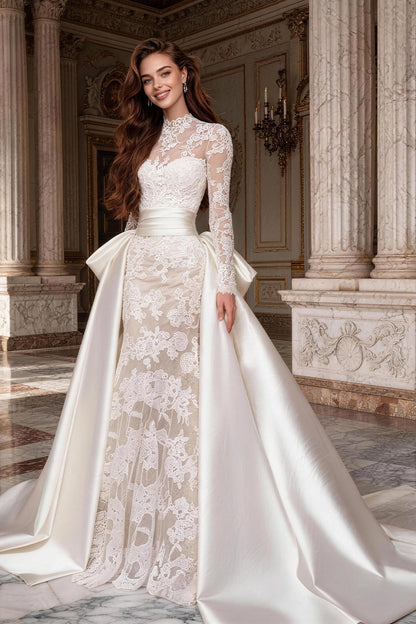 Fitted, ruched wedding gown featuring white tulle, satin, and a voluminous skirt.